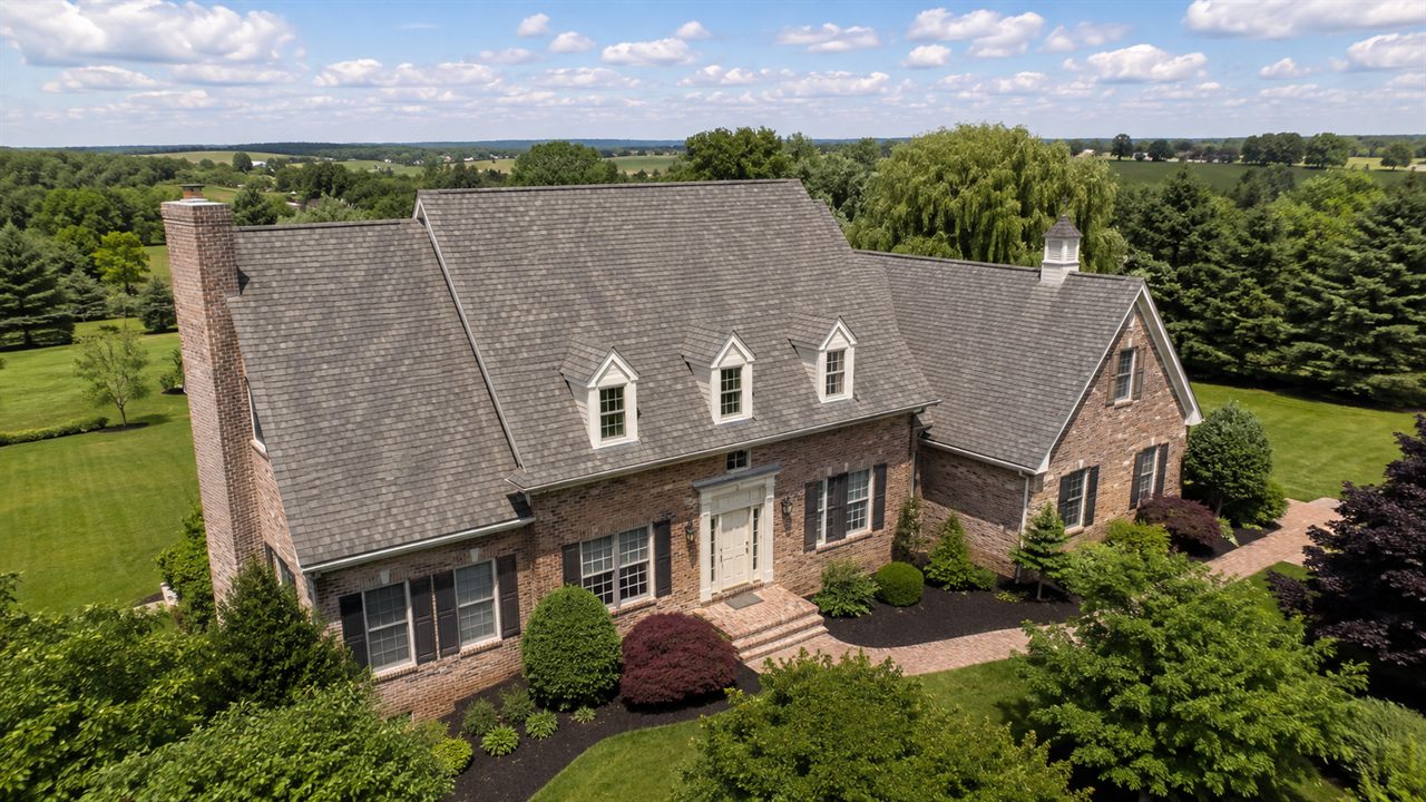 Aerial view of a multi-building property with asphalt shingle roofs in Pennsylvania
